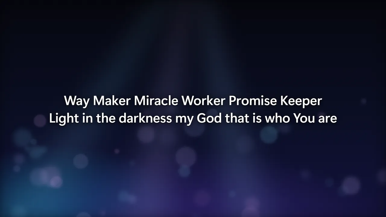The projector showing the chorus of Way Maker over a soft stage-light background
